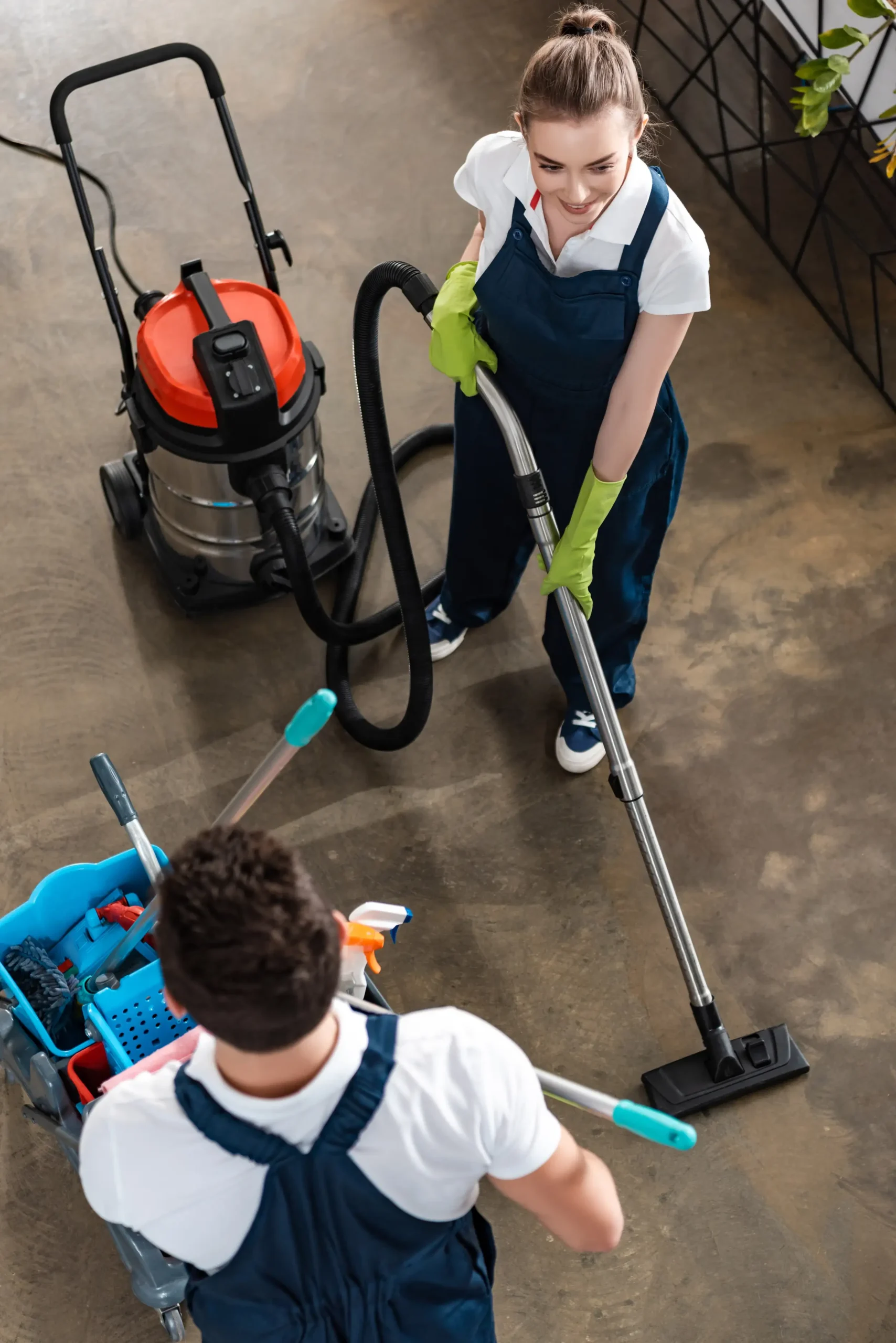 Two workers carefully cleaning the office building.