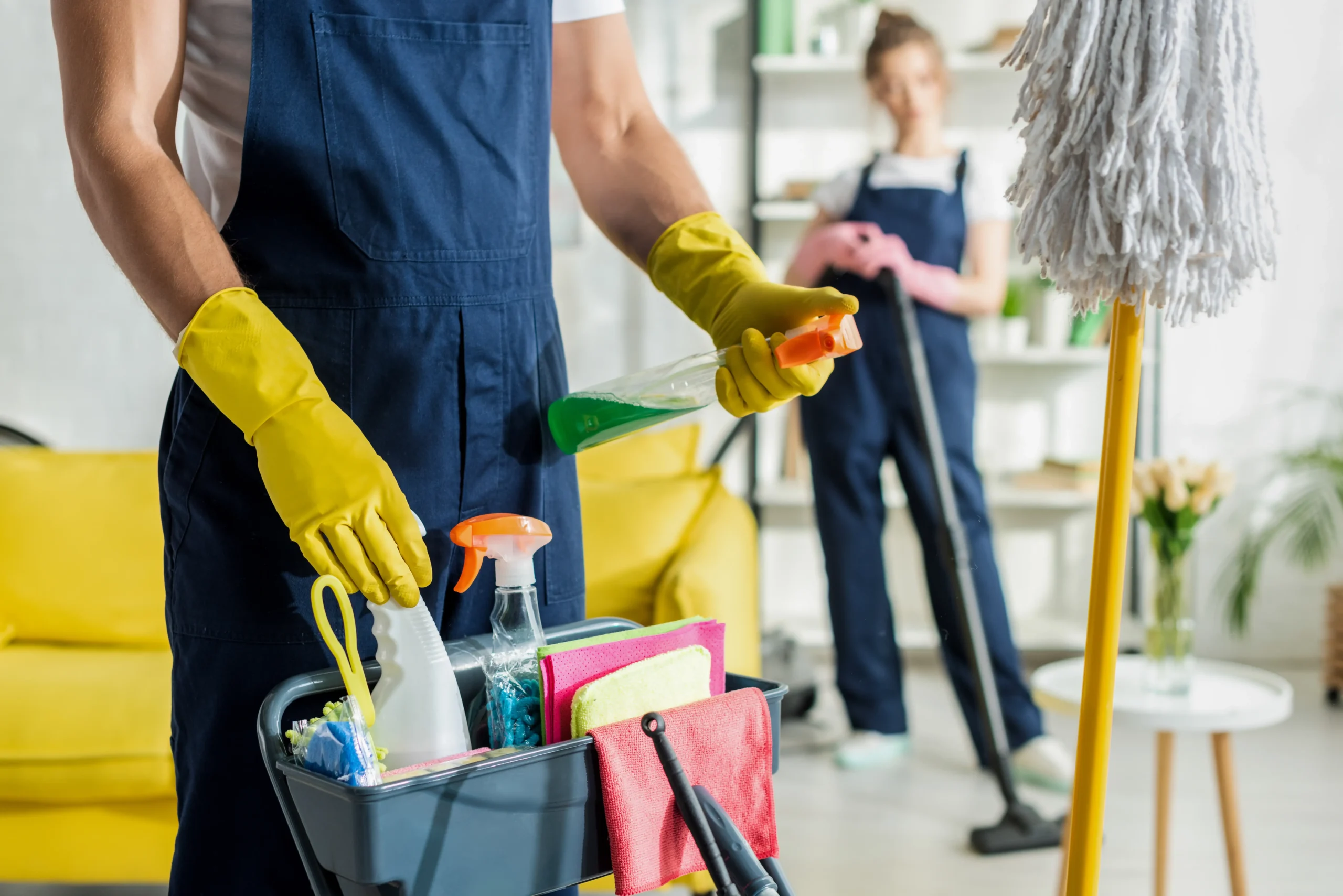 A zoomed image of a cleaner holding and carrying a cleaning items.